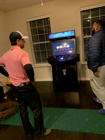 Men Watching Arcade Game Load