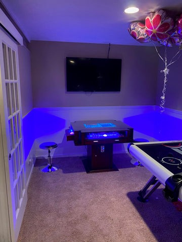 Blue-lit Game Room With Arcade