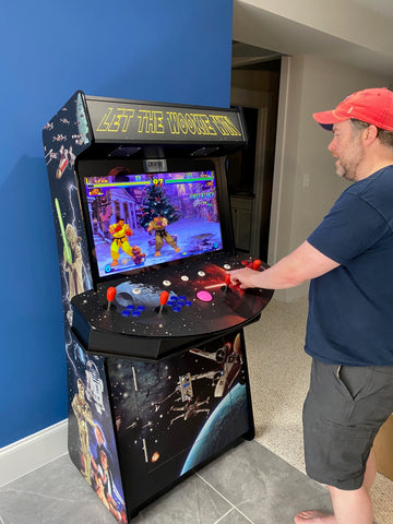 Man playing a Star Wars-themed arcade machine