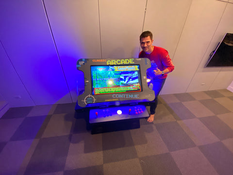 Man With Classic Arcade Cocktail Table Machine