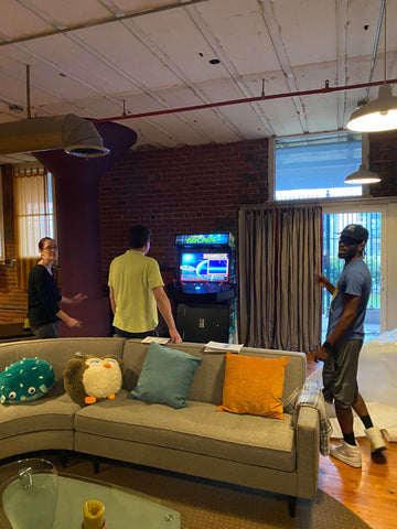 People Playing Games In An Arcade Machine