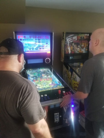 Men Playing Virtual Pinball