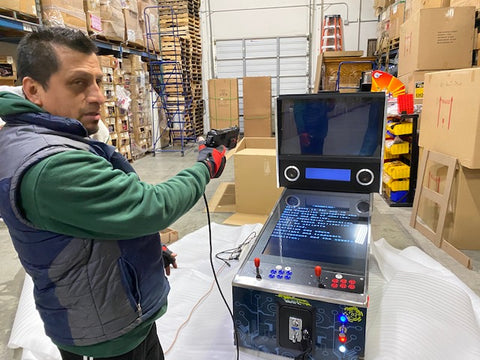 Man playing a virtual pinball machine with a light gun